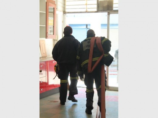 Firefighters on the scene where rubbish caught alight in a courtyard.