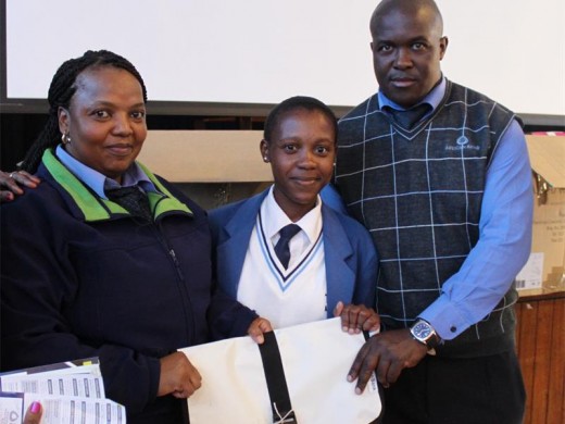 Noxolo Dube, a Town View High School pupil, receives a school bag with snacks and stationary from Key West African Bank branch managers Yvonne Ndaba and Thabo Tsotseti.