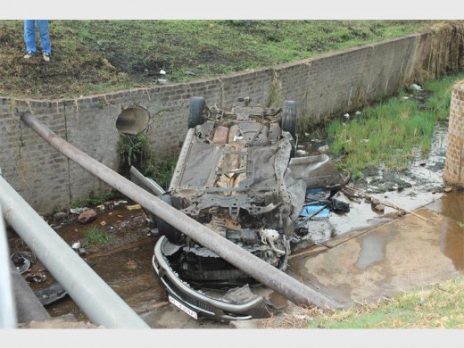 The wheel of the wrecked vehicle was already stripped after it crashed into the spruit.