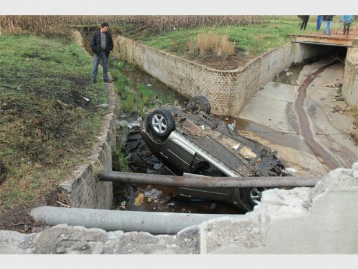 The cement bridge damaged after a vehicle crashed into the spruit.