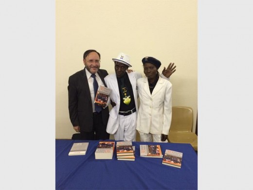 Jack gives a copy of 30 Nights in a Shack to Jeremiyah and Elizabeth Biyela.