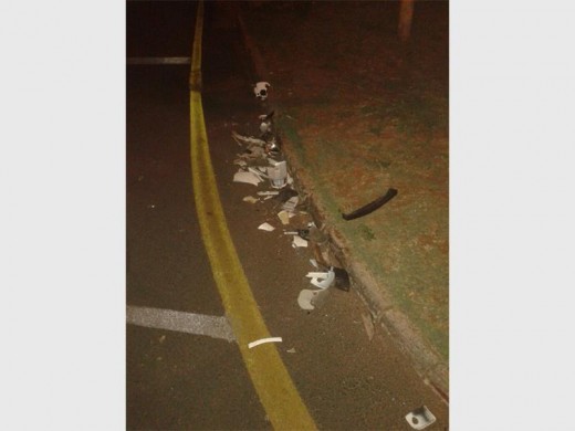 Scooter parts scattered along the road following a hit-and-run incident.