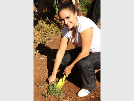 Christina de Sa getting rid of the unwanted plants.