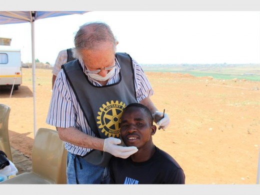 Doctor David Janelowitz does a dental check on 19-year-old Josea Sithole.