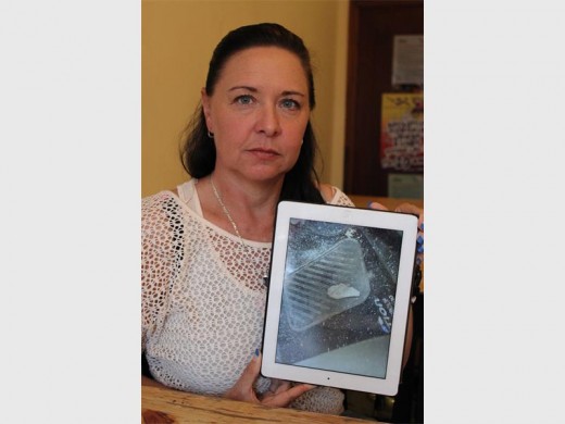 Christa Seidler shows the picture she took of the ear she found in her car after the accident.