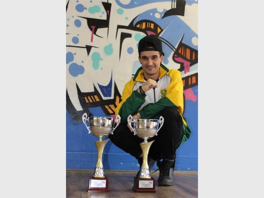 Mario Gomes is proud of his dancers' achievements at the Hip-Hop World Championship. Here he is in front of the two second place trophies the academy won.
