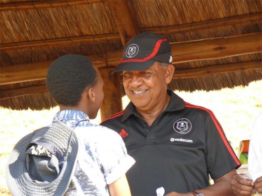 Augusto Palacios hands over a soccer kit to one of the Smart Boys.