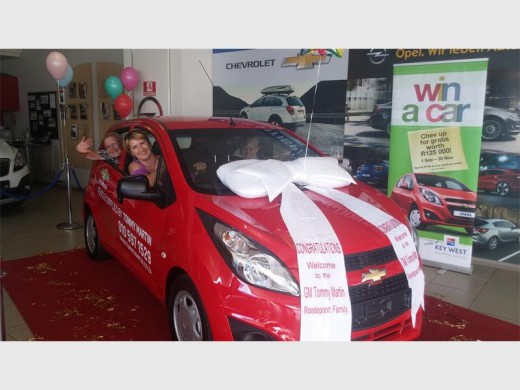 Cindy Neethling about to drive away in her new car she won. Gary Klette  from the Tommy Martin Key West dealership is in the back seat.