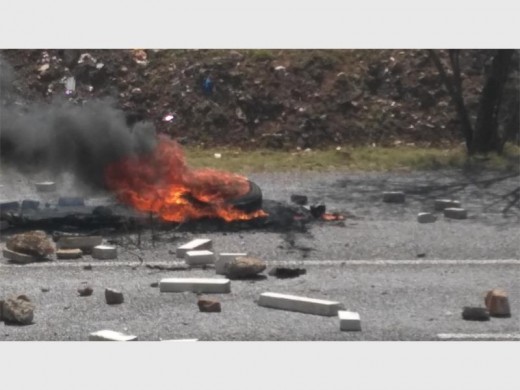 Tyres burned and concrete slabs laid scattered across the road.