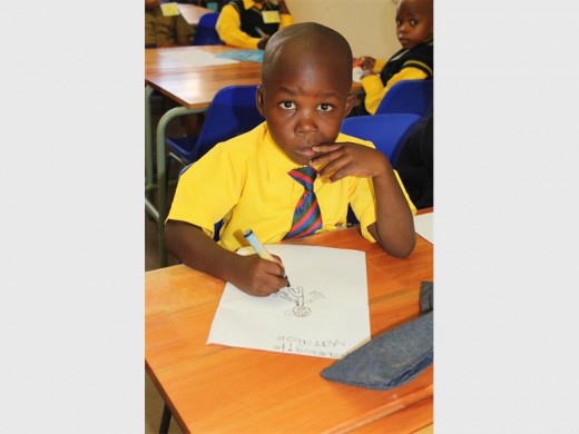 Smart Reabotswe Mokaleng from Lewisham Primary can write his name and draw a picture.