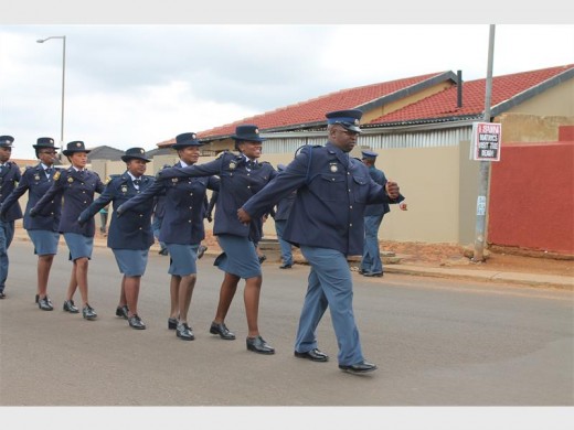 Officers dressed in uniform parade the street to welcome Pastor Irene Tshifhiwa.