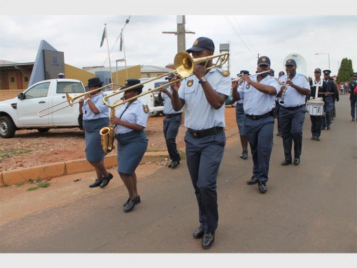 The police's brass band parade down the street for a special police event.
