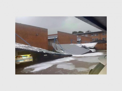 Police vehicles caught under a destroyed roof. Photo: Crime Intelligence and Community Awareness (Cica).