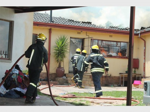 Mogale City Emergency Services firefighters preparing to enter the burning commune.