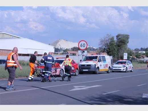 Paramedics run with the unconscious patient to the helicopter to be airlifted to hospital.