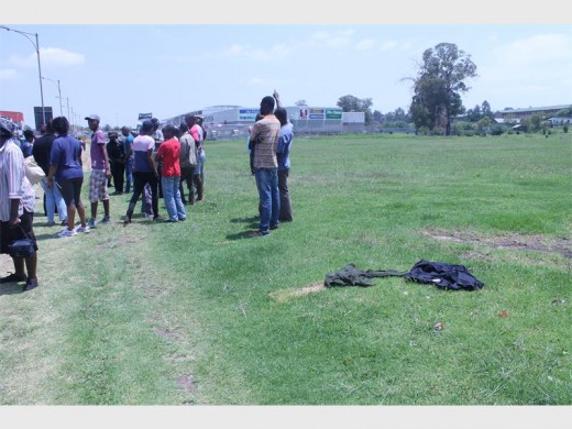 Bloody clothes lie in the field after a mob justice incident earlier today.