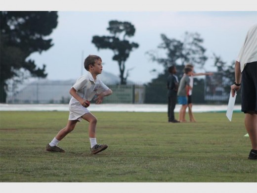 A young player runs as he is ready to deliver the ball.
