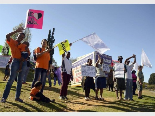 Residents united mear a busy intersection in a peaceful protest against racism.