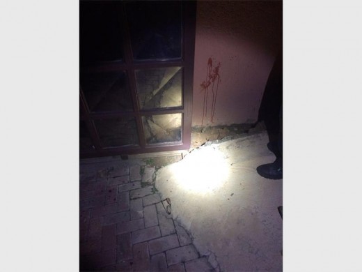 Blood splatters on the wall and bloody glasses at the front gate where the resident was ambushed and attacked.