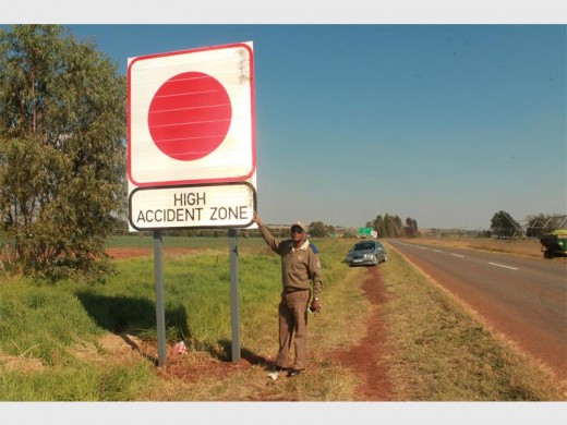 Mogale City Traffic Department Spokesperson Papi Motuang next to the high accident zone signs which were put up on all the roads leading to the so-called 'road of death' intersection on the N14.