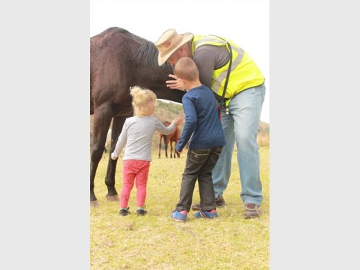 Len Coetzer leads Amber Jones and Zayden Coetzer to the friendly horse who came to greet.