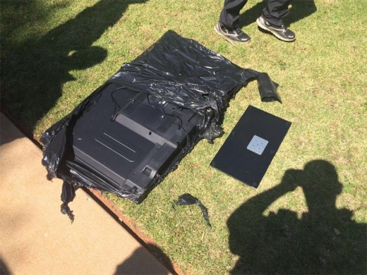 The TV was wrapped in a black plastic bag.