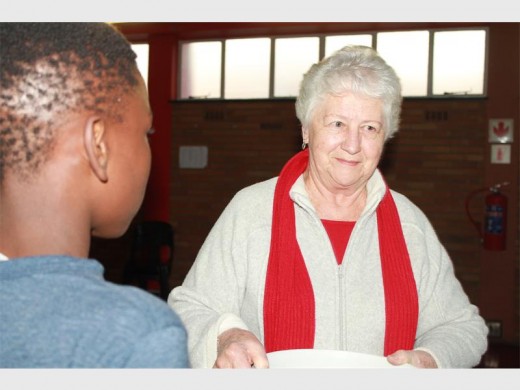 Nellie Davies handing out home-baked cookies to the boys at the Ikusasa Development Centre.