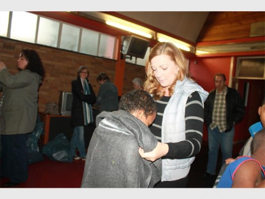 Amorie Coetzer wraps a boy in a warm blanket at the Ikusasa Development Centre.