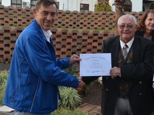 Jacques Hoon, head of the Mogale Caucus, handing Eddie Sloan his service award.