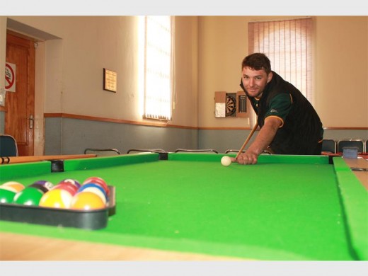 Nico Theron taking a shot at pool at the Meeting Meeples event.