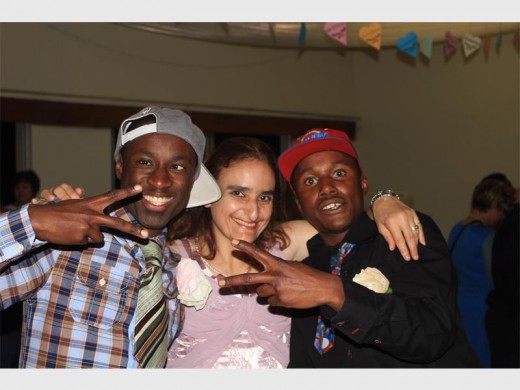 Kefentse Thekiso, Natalie Cost, and Bongani Sishange, residents of Logwood Village enjoying each other’s company at their annual spring dance on Saturday, 3 September.
