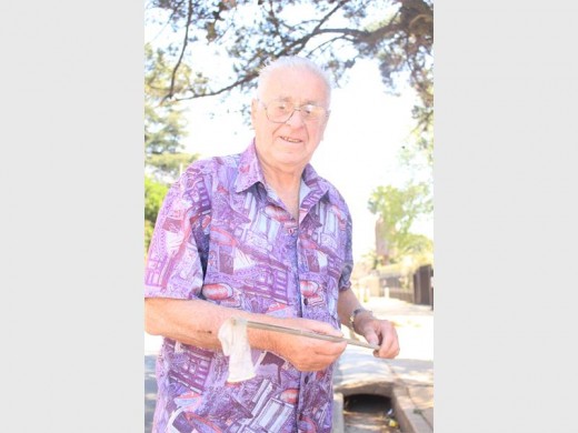 Sepp Dubs, resident of Burger Street, disposing of one of the many condoms lying outside his home.