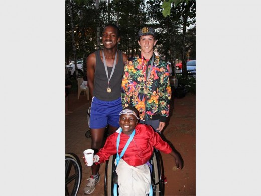 Khosa Running Club runners with a disabled participant, all proudly wearing their medals. Photo: Submitted.