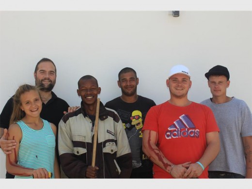 A group of Grace House residents painted the palisade fencing of the Suiderlig church in Krugersdorp West to launch their Restoration Hand project.