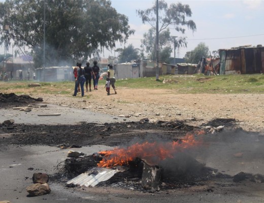 Protesters barricaded a section of Tudor Road with burning tyres and rubble to oppose the councillor's decision to move 50 people from Soul City to houses in Kagiso that were allegedly meant for residents of Tudor Shaft.