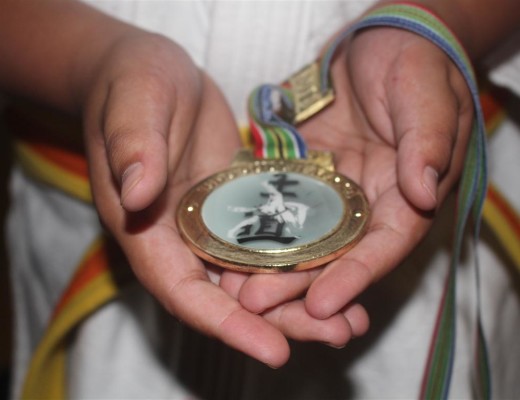A judoka of KJK holds the gold medal he won at the South African Primary Schools Judo Tournament.