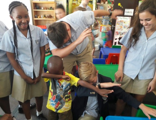 Making time for some play, Maragon learners and a child practice dabbing, a popular dance move.