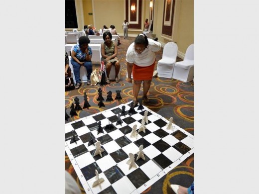 A teacher is about to make a strong move during a chess game against one of her peers.  Photo: Tsogo Sun
