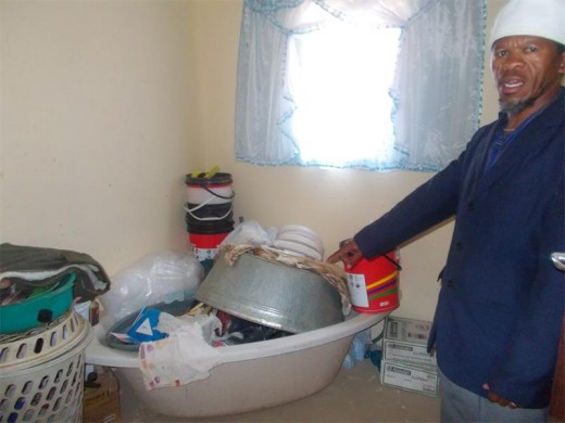 Patrick shows his main bathroom where no toilet or bathtub was installed by builders.
