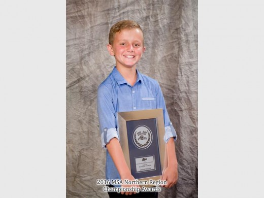 Jordan Brooks smiles with his MSA Northern Region Championship awards at the age of 10. Photo: Supplied