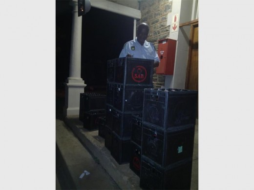 A member of the police with the illegal alcohol. Photo:submitted.