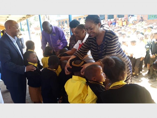 MEC Nandi Mayathula-Khoza distributing school uniform to learners at Tarlton Primary School.