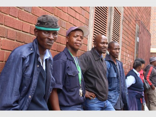 Joseph Pelena and Thapelo Rathebe stood among their fellow employees waiting for their employers to return to their office in Ockerse Street.