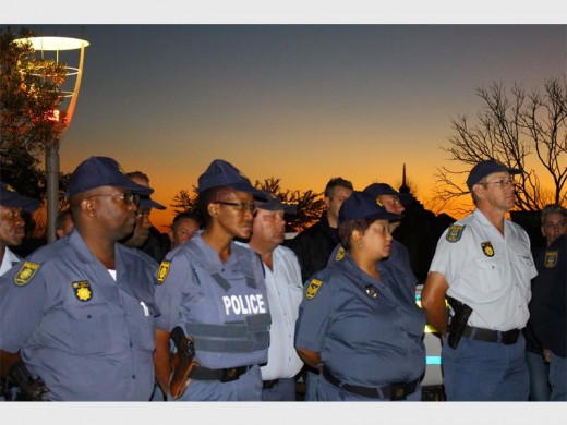 Police officers from various police stations in the West Rand Cluster stood in formation in front of Captain Slabbert awaiting instructions. Among them were various security guards dressed in camouflage and black uniforms.