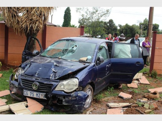 The car involved in the T-bone collision veered out, but was driven through a residential wall.  Photo: Bianca Pindral