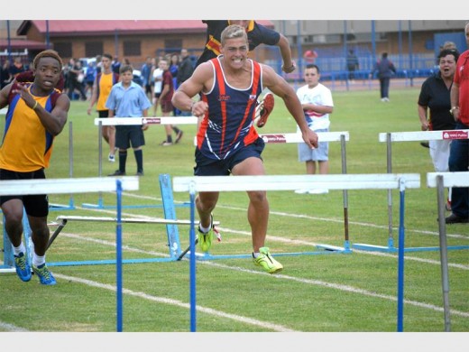 Riaan de Jager, 'n atleet van Hoërskool Bastion hardloop volspoed na die volgende hekkie toe nadat hy een omgestamp het. Foto: Monique Naudé