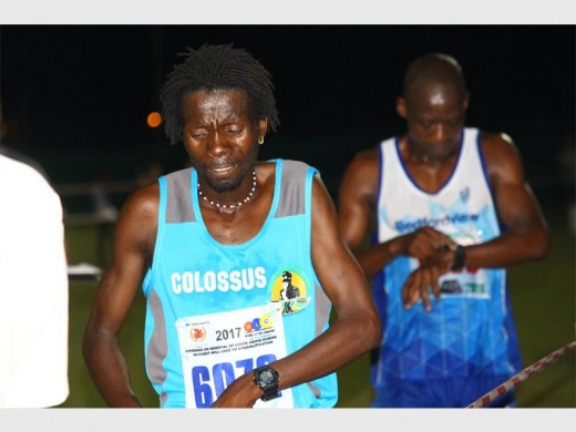 Libonto Tootse, who came in second place, arrived at the finishing line moments after the first runner. In third place Abram Khumalo, stopped his watch to see his race time.