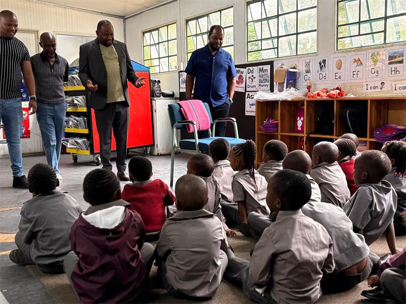 Mayor Lucky Sele donates school shoes to Munsieville learners and encourages them to reach their full potential.