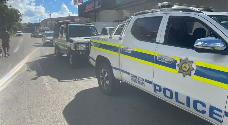 CIT officers were held at gunpoint while loading cash, with the gunmen still on the run.