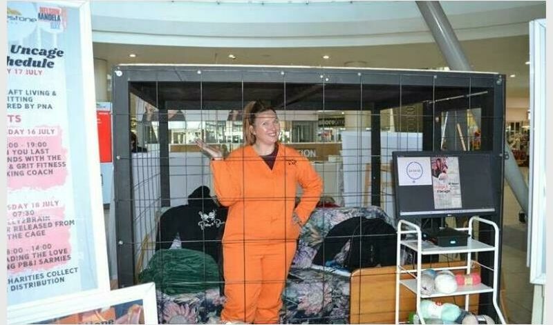 Belly2Brain founder Dominique Tibbles will lock herself in a cage again to raise R110 000 and make 20 000 peanut butter and jam sandwiches for local NPOs and feeding schemes.
